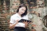 Portrait Of Thai Adult Student University Beautiful Girl Using Her Tablet Stock Photo