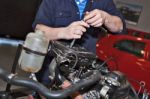 Man Holding A Spanner Over A Car Engine Stock Photo