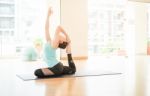 Asian Woman Doing Yoga Indoors Stock Photo