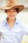 Asian Woman Wearing Cowboy Hat And Smiling Stock Photo