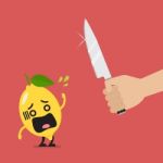 Hand With A Knife Prepare To Cut Shocked Lemon Stock Photo