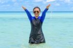 Happy Asian Teen Girl Play Splashing Water In The Sea Stock Photo