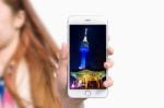 Hand Holding Smart Phone With Photo Of Seoul Tower Isolated On White Background Stock Photo