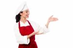 Female Chef Presenting Something Stock Photo