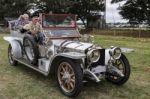 Three People Sitting In A Vintage Silver Rolls Royce Stock Photo