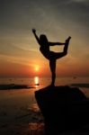 Silhouette Yoga Girl By The Beach At Sunrise Stock Photo