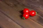 Fresh Tomatoes On The Dark Wooden Table Stock Photo