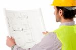 Man Wearing Hard Hat Reviewing The Plan Stock Photo