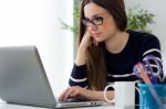 Confident Young Woman Working In Her Office With Laptop Stock Photo