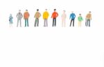 Group Of Miniature People Standing On White Background Stock Photo