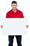 Smiling Guy Presenting Blank Board Stock Photo