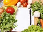 Note Book Among The Vegetables Stock Photo