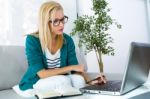 Pretty Young Woman Working With Laptop At Home Stock Photo