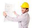 Smiling Construction Engineer Reviewing Blueprint Stock Photo