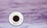 Top View Of Coffee Cup On Purple Wooden Background Stock Photo