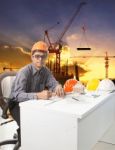 Engineering Man With Safety Helmet Working Table Against Buildin Stock Photo