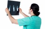 Surgeon Examining The X-ray Report Stock Photo