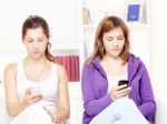 Two Teenage Girs With Mobile Phones Stock Photo