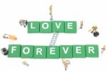 Miniature Worker Team Building Word Love Forever On White Background Stock Photo