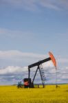 Oil Well In Canola Field Stock Photo