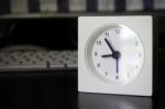 White Clock, On Business Table In The Office Stock Photo