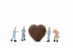 Miniature Worker Making Heart Shaped Chocolate On White Backgrou Stock Photo