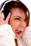 Side Pose Of Screaming Woman Listening To Music Stock Photo