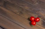 Fresh Tomatoes On The Dark Wooden Table Stock Photo