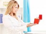 Woman Opening Fancy Box At Home Stock Photo