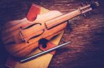 Violin And Notebook With Pen On Grunge Dark Wood Background Stock Photo