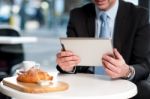 Handsome Manager Using His Tablet Device Stock Photo