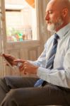 Businessman Middle-aged Working From Home With A Tablet Stock Photo