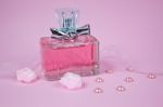 Pink Aromatic Perfume With Pink Pearls And Pink Textile Roses On Pink Background Stock Photo