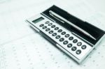 Pocket Calculator And Pen On The Table Stock Photo