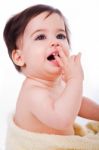 Baby With Finger In Mouth Looking Up Stock Photo