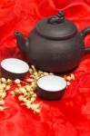 Jasmine Tea Over Red Silk Stock Photo