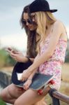 Beautiful Young Women Using Mobile Phone In The Street Stock Photo