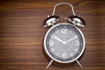 Alarm Clock On Wooden Background Stock Photo