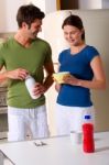 Loving Couple In Kitchen Stock Photo