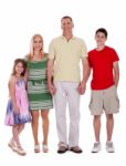 Happy Family Standing By Holding Their Hands Stock Photo