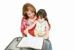 Minority Woman And Her Daughter Reading The Bible Stock Photo