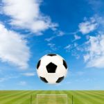 Soccer Ball With Soccer Field Against  Blue Sky Background Stock Photo