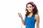 Pretty Woman Enjoying Music Stock Photo