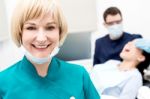 Male Dentist Doing Teeth Checkup Behind Stock Photo