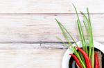 Red Hot Chilli Pepper And Scallions On Plate Stock Photo