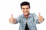 Successful Young Man Giving Thumbs Up Stock Photo