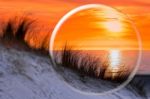 Glass Sphere Reflecting Orange Sunset Stock Photo