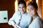 Two Pretty Business Women Working In The Office Stock Photo