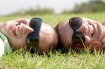 Couple Laying On Lawn Stock Photo