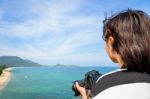 Teenage Girl Is Holding Camera On High Stock Photo